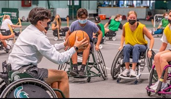 Michigan State University students play wheelchair basketball at the East Lansing campus.