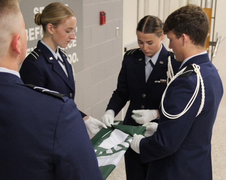 U.S. Air Force ROTC cadets folding Spartan flags