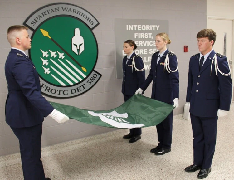 U.S. Air Force ROTC cadets folding Spartan flags